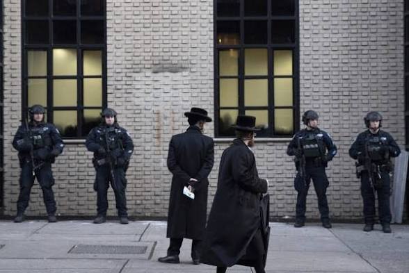 Orthodox Jewish men walking past police